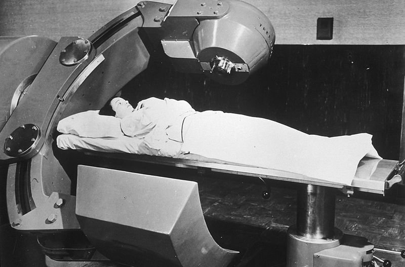 Shows photo of person receiving Cobalt 60 cancer therapy.