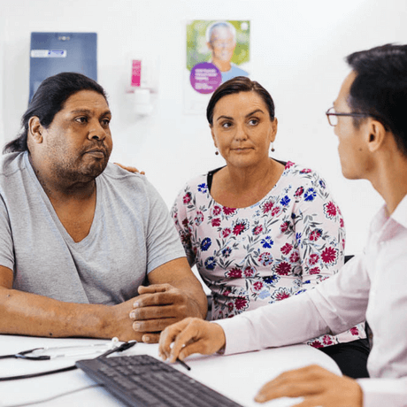 An Aboriginal couple speaking with their GP